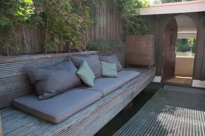 a couch with pillows sitting on a patio at Boathotel in Amsterdam