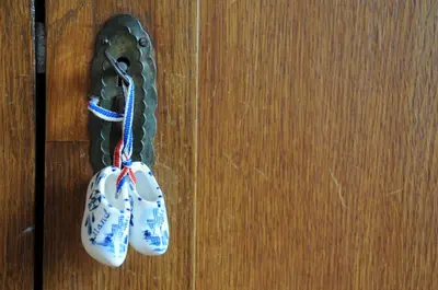 a pair of bells hanging on a wooden door at Boathotel in Amsterdam