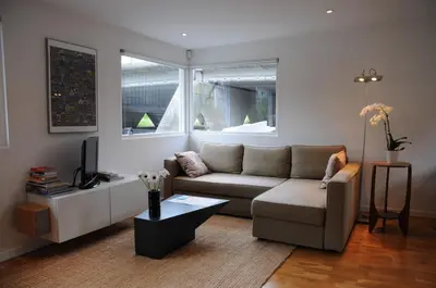 a living room with a couch and a tv at Boathotel in Amsterdam