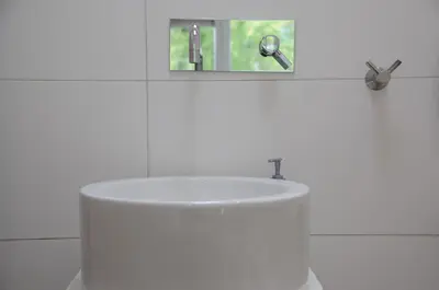 a white bathroom with a sink and a mirror at Boathotel in Amsterdam