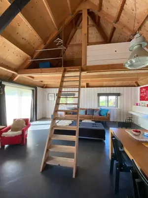 a loft bed in a tiny house at Groeten uit Hoogmade - rural cottage in Hoogmaden