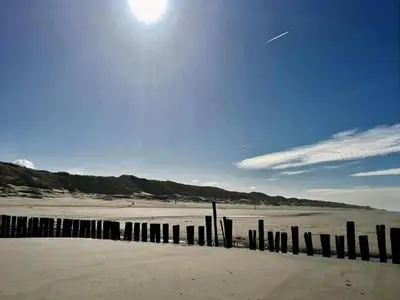 a beach with a fence in the sand at Apartment in North Holland in Bergen aan Zee