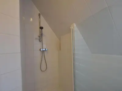 a shower with a shower head in a bathroom at Apartment in Bergen aan Zee near the Beach in Bergen aan Zee