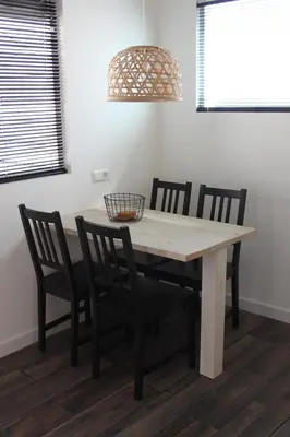 a dining room table with chairs and a light fixture at Viale in Egmond aan Zee