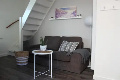 a living room with a couch and a table at Viale in Egmond aan Zee