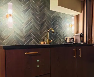 a kitchen with a sink and a tile wall at SeventyFive in Amsterdam