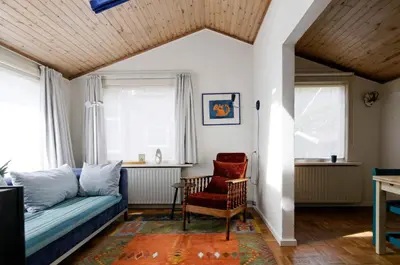 a living room with a couch and a chair at holiday cottage 'FLOW' in Bergen