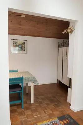 a dining room with a table and a ceiling at holiday cottage 'FLOW' in Bergen
