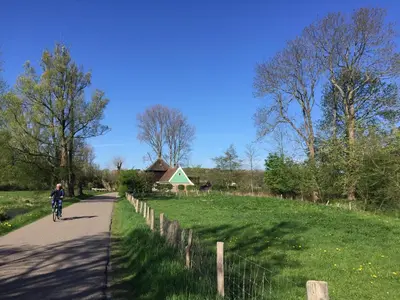 a person riding a bike down a road at holiday cottage 'FLOW' in Bergen