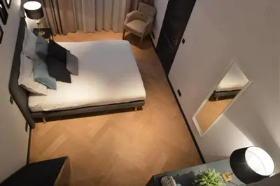 a living room with a white couch and a table at Romantic ground floor suite in Pijp near Sarphatipark in Amsterdam