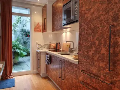 a kitchen with a sink and a counter top at Huis Roomolen in Amsterdam