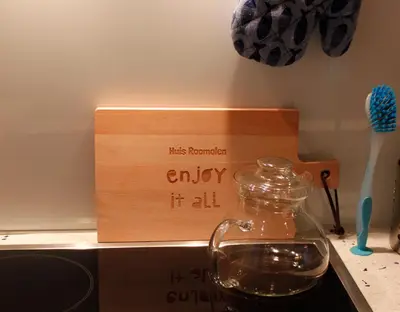 a wooden box with a bottle of water in it at Huis Roomolen in Amsterdam