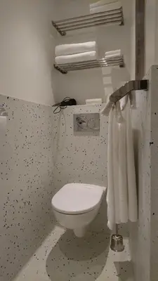 a bathroom with a white toilet in a room at Huis Roomolen in Amsterdam