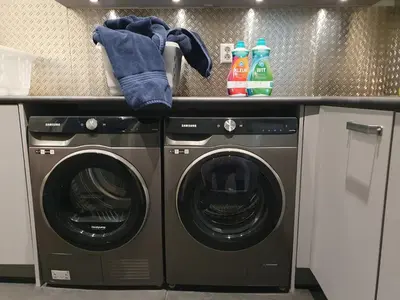 a laundry room with two washing machines and a counter at Huis Roomolen in Amsterdam