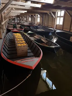 a group of boats sitting in the water at Logeren op Dijk43 in Broek op Langedijk