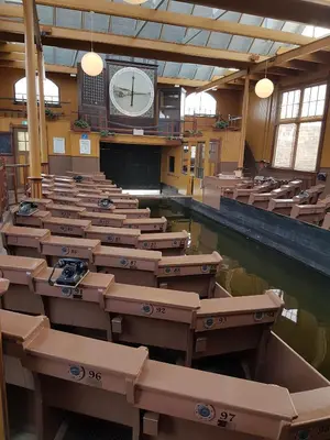 a large room with rows of desks and a clock at Logeren op Dijk43 in Broek op Langedijk