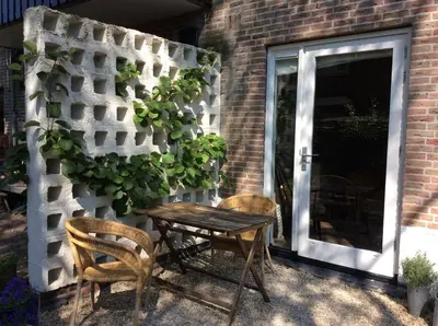 a wooden table and two chairs next to a door at B&B PeperZzz in Bergen