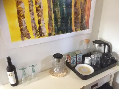 a kitchen counter with a painting on the wall at B&B PeperZzz in Bergen
