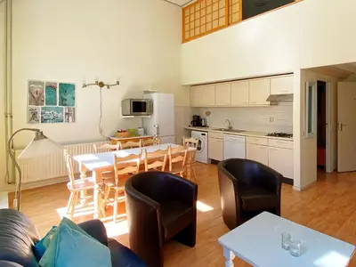 a living room with a kitchen and a table and chairs at Holiday Home in Bergen near North Sea Beach in Bergen aan Zee