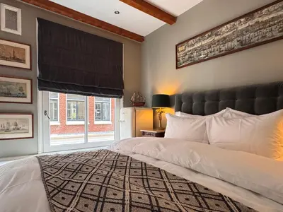 a bedroom with a large bed and a window at The Lastage Inn - Bed & Breakfast in Amsterdam