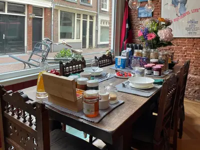 a wooden table with food on top of it at The Lastage Inn - Bed & Breakfast in Amsterdam