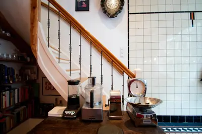 a kitchen counter with a blender on a counter next to a staircase at The Lastage Inn - Bed & Breakfast in Amsterdam