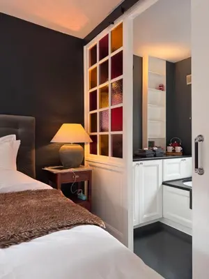 a bedroom with a bed and a table with a lamp at The Lastage Inn - Bed & Breakfast in Amsterdam