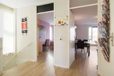a living room with a table and a dining room at Johan's B&B - Since 2014 roofterrace and cheap parking in Amsterdam