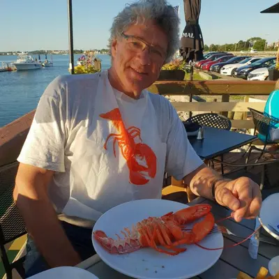 a man sitting at a table with a plate of lobster at Johan's B&B - Since 2014 roofterrace and cheap parking in Amsterdam