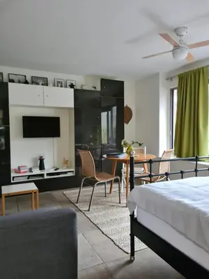 a bedroom with a bed and a table and chairs at GREAT CANAL STUDIO - AC, Water view & Free parking in Amsterdam