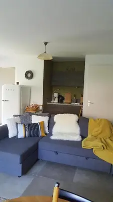 a blue couch with pillows on it in a kitchen at GREAT CANAL STUDIO - AC, Water view & Free parking in Amsterdam