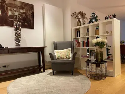 a living room with a chair and a book shelf at Luxury Prinsengracht Canal House Jordan Area in Amsterdam