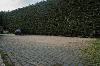 a car parked in a parking lot next to a hill at Veldzicht in Winkel