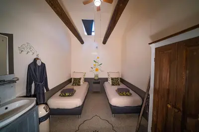 a small room with two beds and a sink at Veldzicht in Winkel