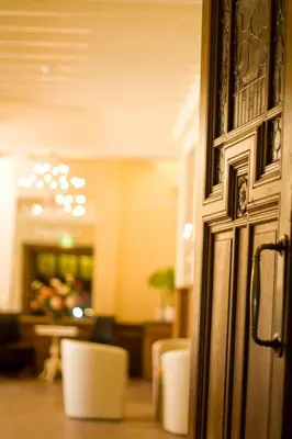 a close up of a door in a room with chairs at Landgoed Huize Glory in Bergen aan Zee
