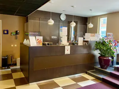 a fast food restaurant with a counter and a clock at Hotel Van Gogh in Amsterdam