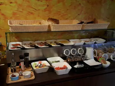 a buffet with bowls and plates of food on a table at Hotel Van Gogh in Amsterdam