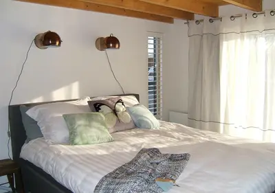 a bedroom with a bed with two teddy bears on it at watervilla-albertje in Amsterdam