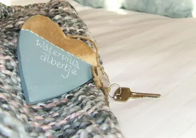 a heart shaped tag on the side of a bed at watervilla-albertje in Amsterdam