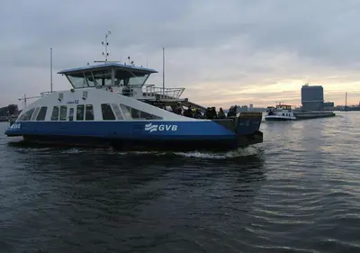 a blue and white boat in the water at watervilla-albertje in Amsterdam
