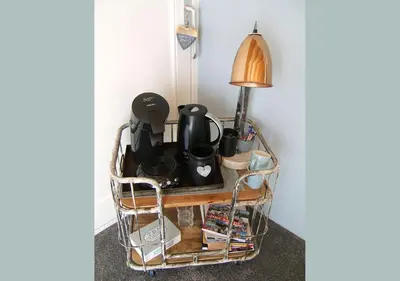 a wire basket with dishes and a lamp on a table at watervilla-albertje in Amsterdam