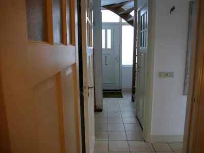 a hallway of a house with a door open at Dar Cho Apartment in Zandvoort