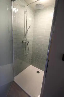 a bathroom with a shower with a glass door at Het Spoorhuis Uithoorn in Uithoorn