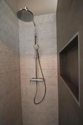 a shower with a shower head in a bathroom at Het Spoorhuis Uithoorn in Uithoorn