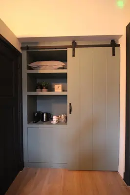 a closet with a white door in a room at Het Spoorhuis Uithoorn in Uithoorn