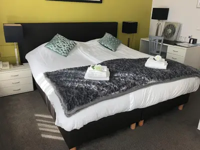 a bedroom with a bed with two towels on it at Hotel de Keizerskroon Hoorn in Hoorn
