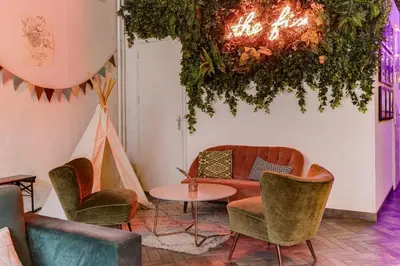 a room with chairs and a couch and a table at ClinkMama in Amsterdam