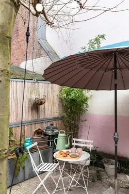 a table and two chairs and an umbrella at ClinkMama in Amsterdam