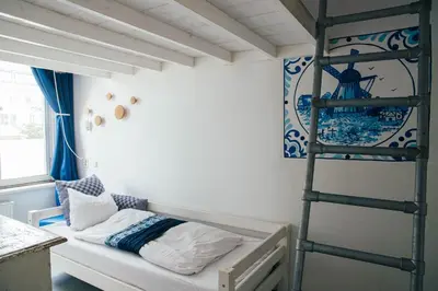 a bunk bed in a room with a ladder at ClinkCoco in Amsterdam