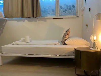 a bed in a room with a window at ClinkCoco in Amsterdam